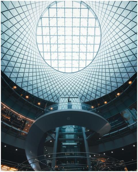 Modern circular glass ceiling with a spiral stairc