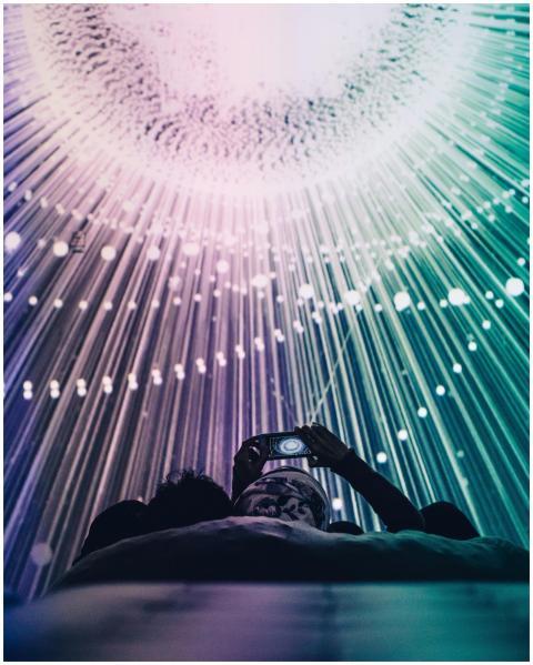 A person captures a captivating light display with