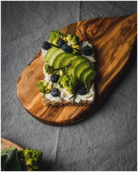 Gourmet avocado toast topped with blueberries and