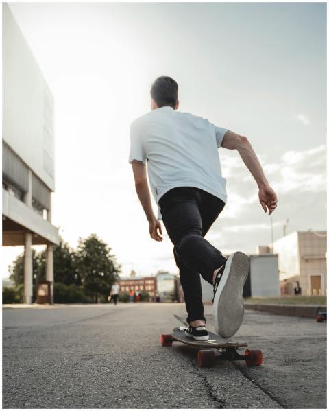 A young man skateboarding energetically in an urba