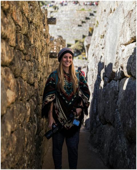 Smiling photographer wearing a traditional poncho
