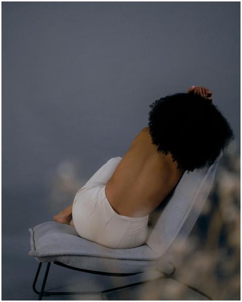 Artistic photograph of a woman posing shirtless on