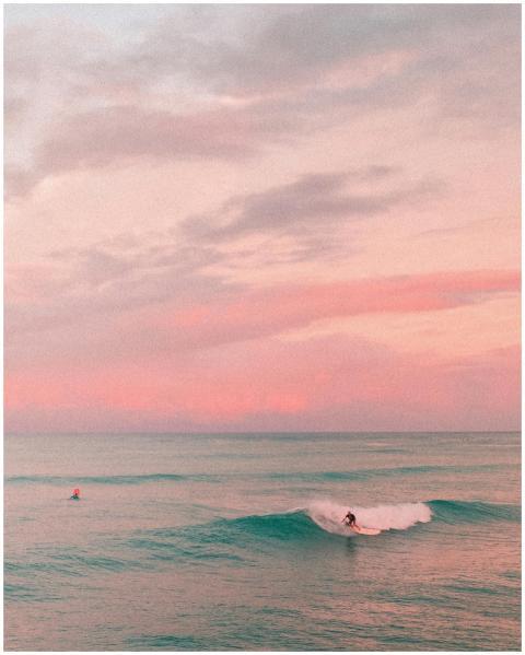 Captivating sunset scene of surfers in Honolulu, H