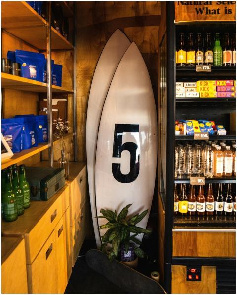 Cozy surf shop corner displaying surfboards and a