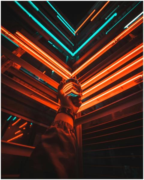 A hand holding a glowing glass ball reflecting vib