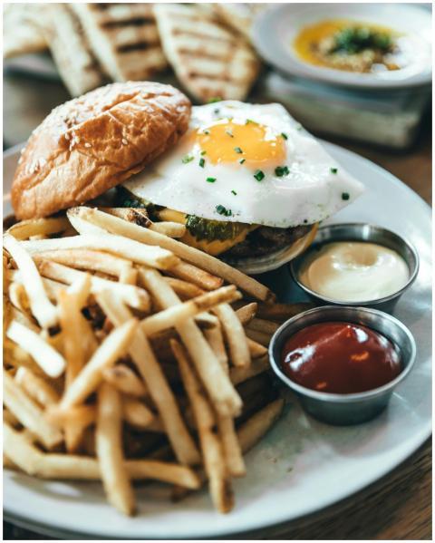 Delicious gourmet burger topped with a fried egg s