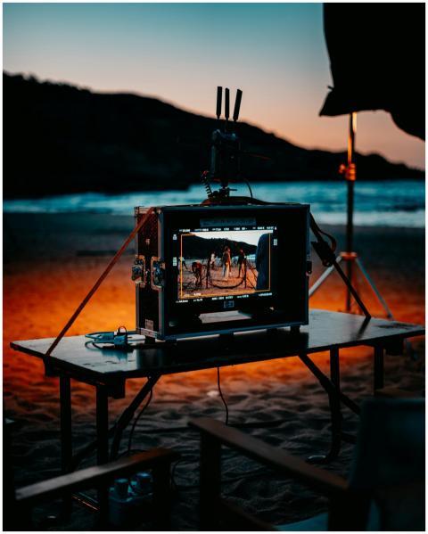 Film equipment on a beach at twilight as a movie i