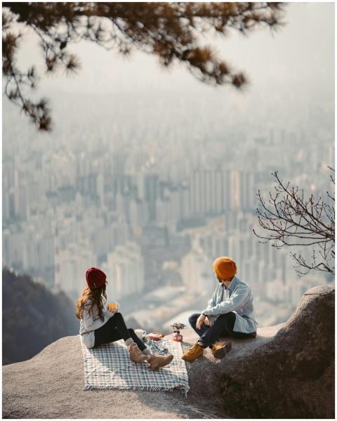 Couple enjoying a scenic picnic with a breathtakin