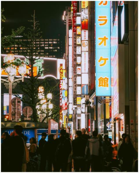Crowded Tokyo street illuminated by colorful neon