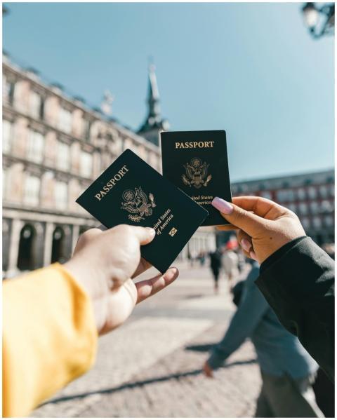 Travelers holding US passports at Plaza Mayor, Mad