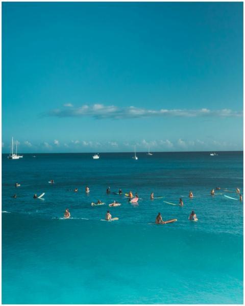A stunning coastal aerial shot capturing surfers e