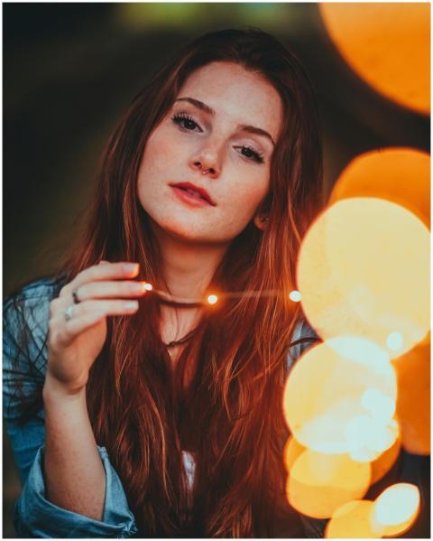 Creative portrait of a young woman with glowing st
