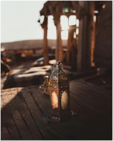 A vintage Moroccan lantern sits in a sunlit, rusti
