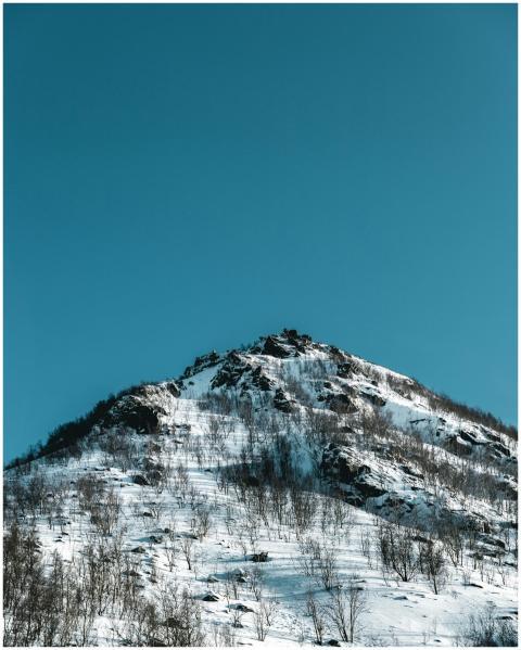 A breathtaking snow-covered mountain peak standing