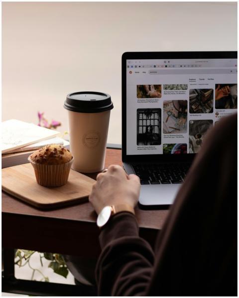 A cozy workspace setup with a coffee cup, muffin,