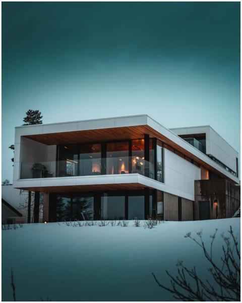 Stunning modern home with glass facade in snowy Tr