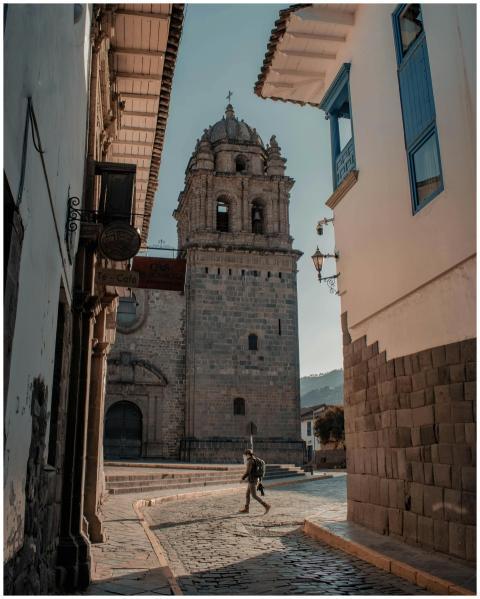 Photograph of a historic tower and cobblestone str