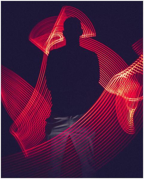 A silhouette of a person surrounded by artistic re