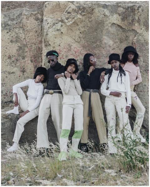 Fashion-forward group posing in trendy outfits by