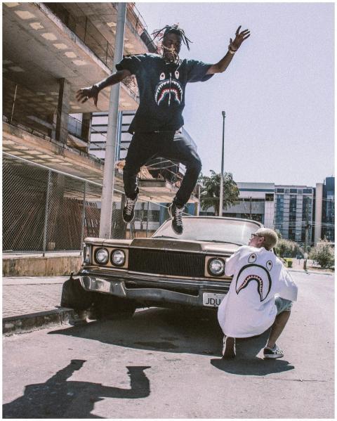 Man jumps in urban setting showcasing streetwear f