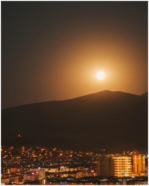 A stunning cityscape under a full moon with vibran