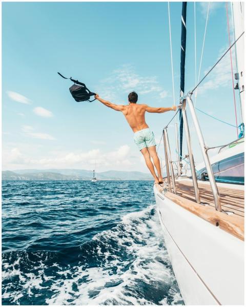 Man enjoying freedom by jumping into the ocean fro