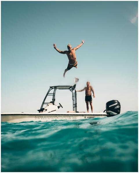 Two men enjoy a sunny adventure, jumping into the