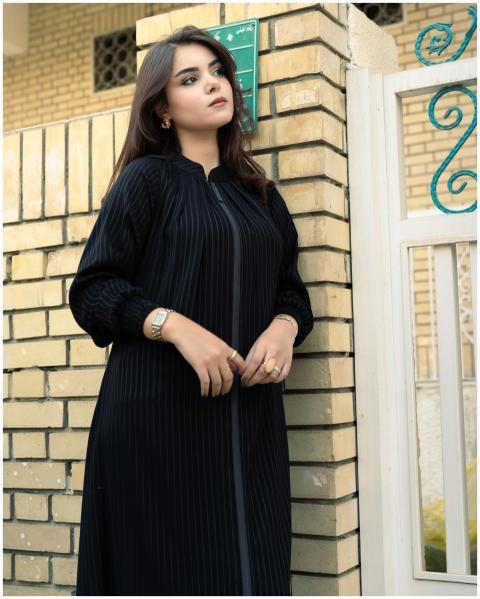 Elegant woman in black attire posing confidently a