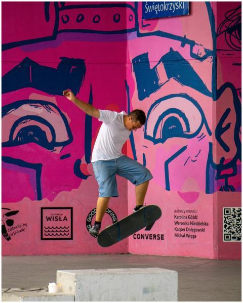 A skateboarder performs a trick in the vibrant Swi