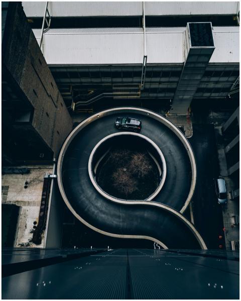 Aerial view of a modern spiral parking ramp in an