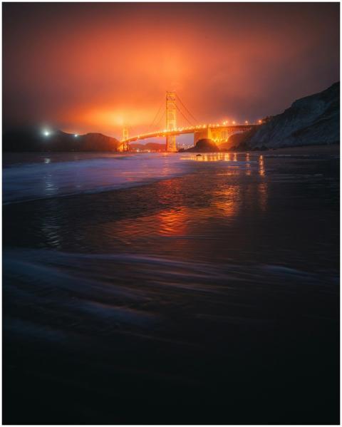 Iconic Golden Gate Bridge reflecting on ocean duri