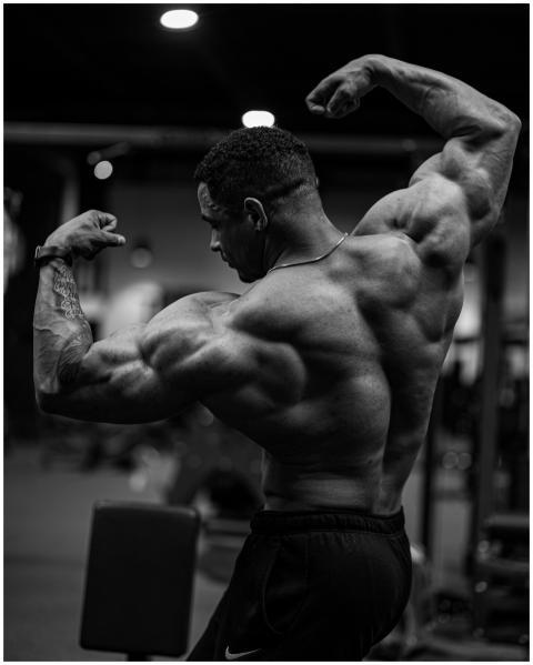 Black and white photo of a bodybuilder flexing mus