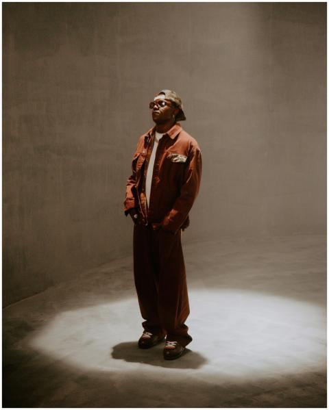 Stylish man in spotlight, wearing trendy outfit in