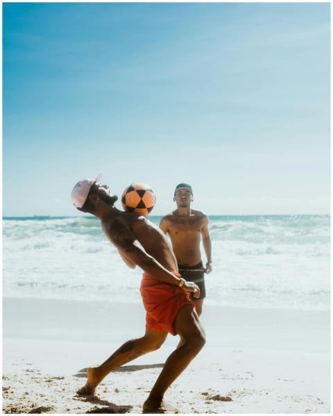 Two men enjoying a fun game of football on a sunny
