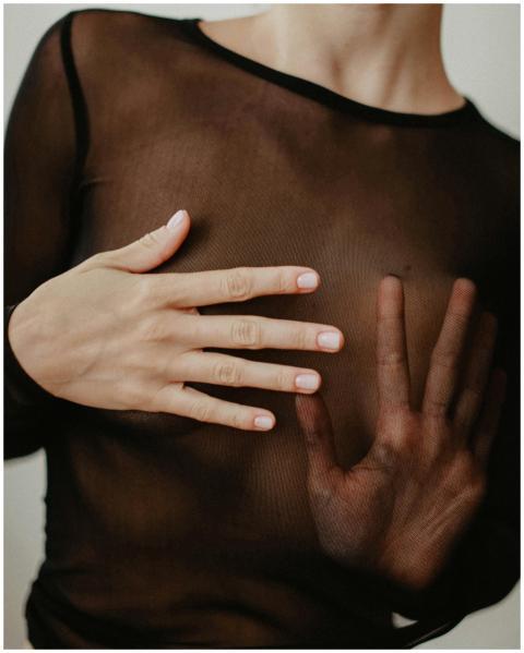 A detailed close-up of hands pressing against shee