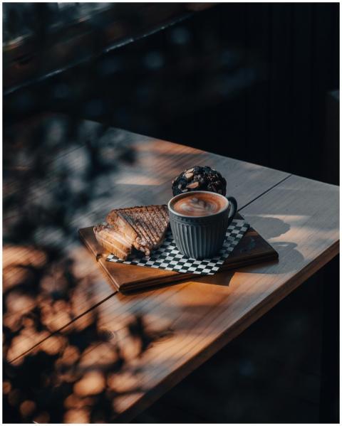Warm setting with cappuccino and toasts on a woode