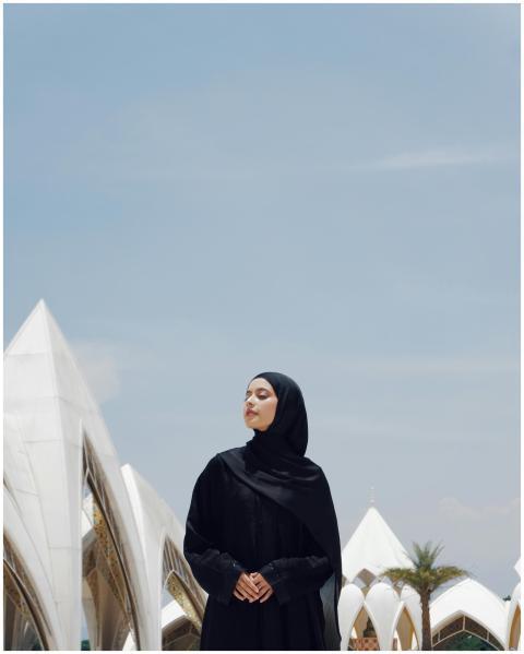 A serene image of a Muslim woman standing at Al Ja