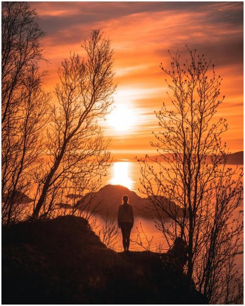 A stunning silhouette of a woman overlooking the s