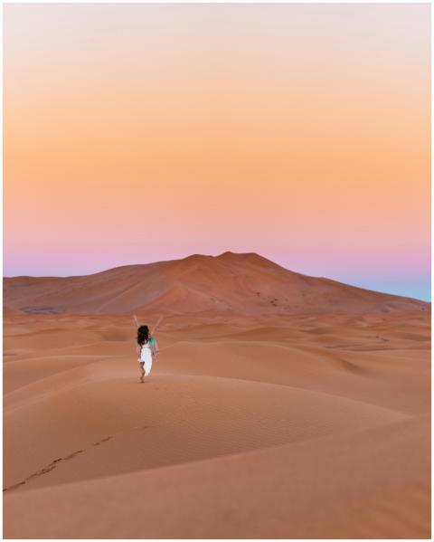 A lone traveler explores the stunning sand dunes o