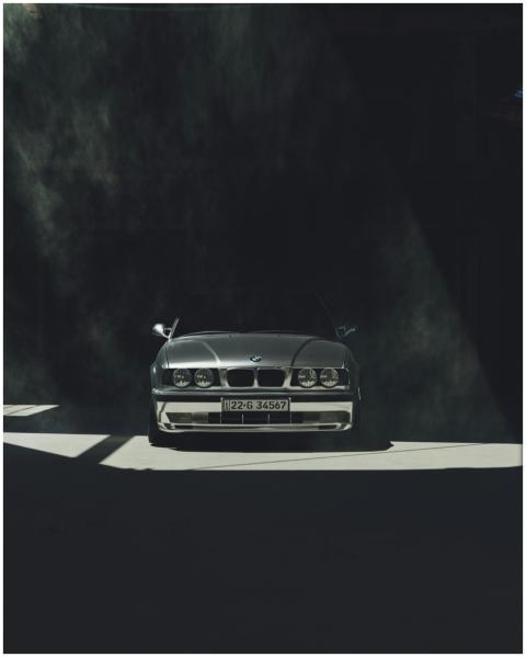Classic BMW E30 captured under moody lighting, sho