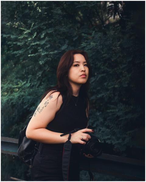 Portrait of a young woman with a tattoo posing ele