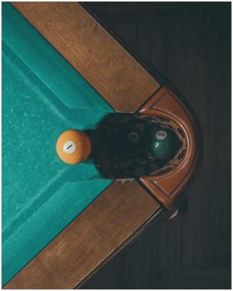 Overhead view of billiard balls near the corner po