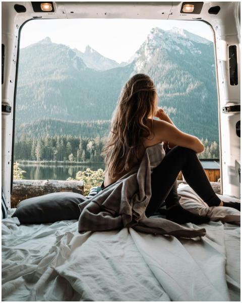 A woman enjoying a peaceful moment inside a camper