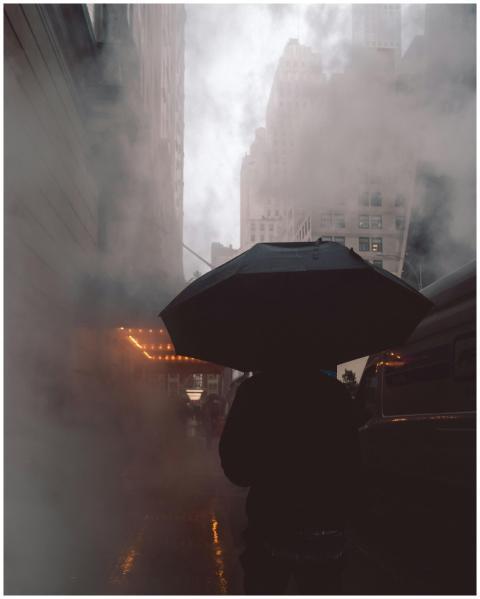 A mysterious silhouette with an umbrella on a fogg