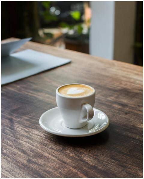 A serene moment with a cappuccino on a wooden tabl