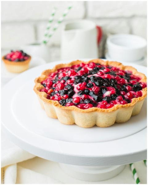 Homemade berry tart with fresh blackberries and cu