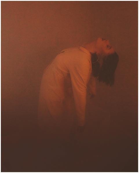 Sensual backlit silhouette of woman in fog, creati