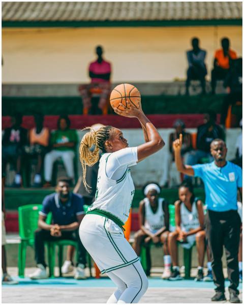 A focused female athlete prepares to shoot a baske
