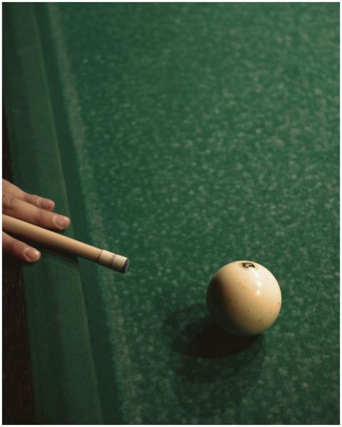 Detailed view of a billiard setup with cue stick a