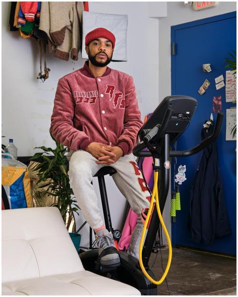 Casually dressed man sitting on a stationary bike